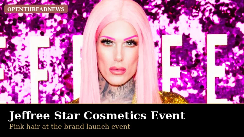 Jeffree Star with pink hair in a gold sequin jacket at a Jeffree Star Cosmetics event with a pink glitter backdrop