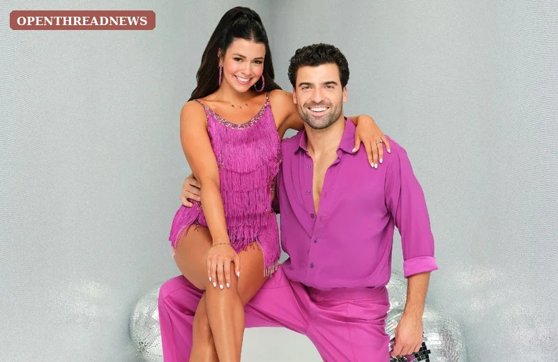 A ballroom couple mid-dance under competition lights, evoking Jen Affleck's run on Dancing with the Stars