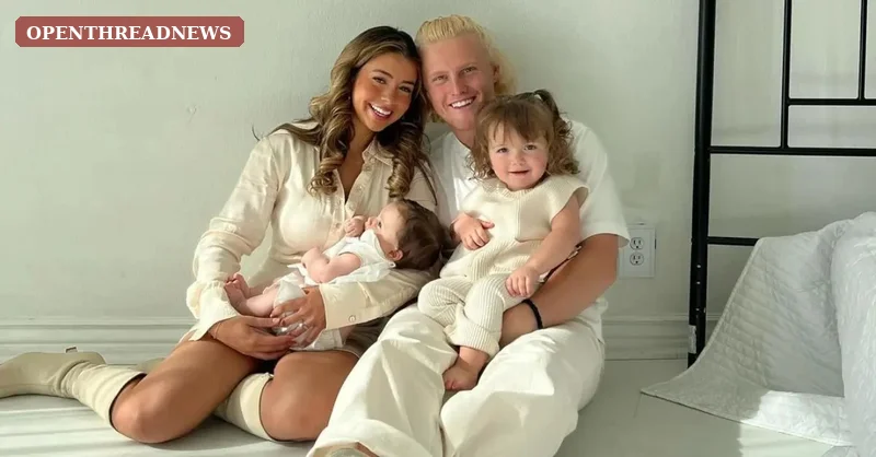 A young mother holding her baby while her two older children play, reflecting Jen Affleck's life as a mom of three