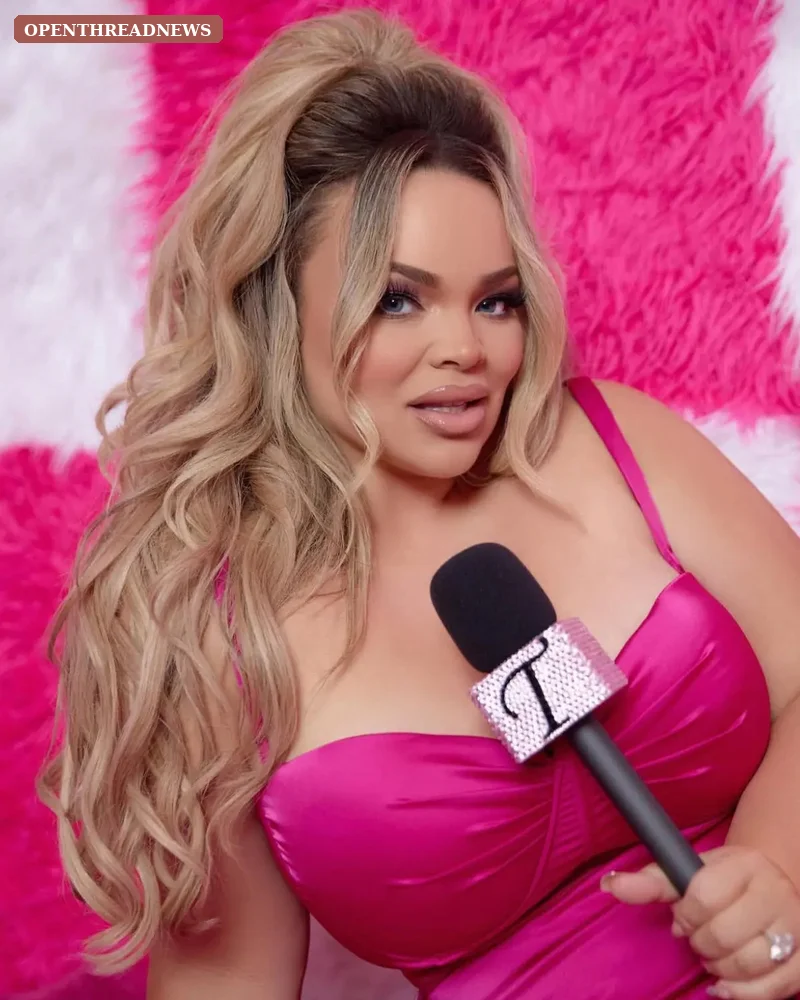 A blonde host recording at a studio microphone with an empty guest chair beside her, for the Just Trish podcast section of Trisha Paytas profile