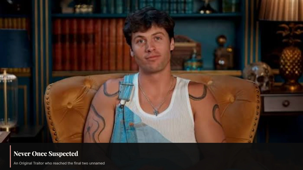 Rob Rausch seated in denim overalls during a Traitors Season 4 interview as an undetected Original Traitor