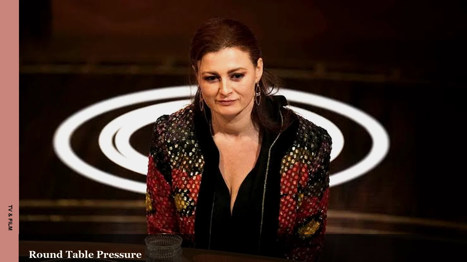 Rachel Reilly seated at a Traitors round table during the castle game
